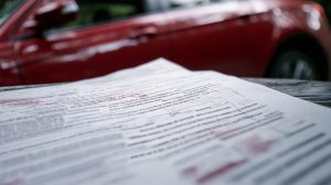 A close-up of an auto insurance policy document highlighting key coverage types, including liability and uninsured motorist.